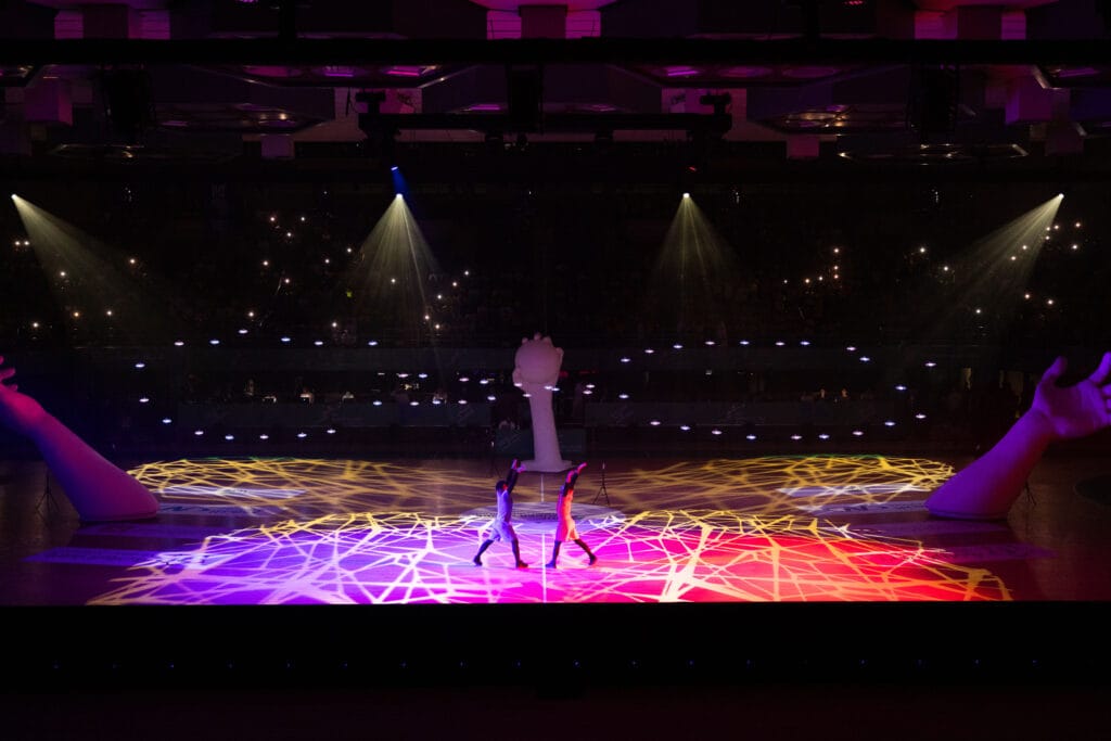 Dancers perform on light show.