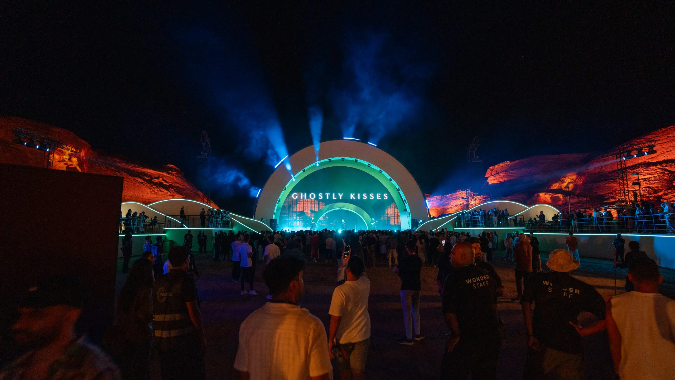 A vibrant night scene of the Ghostly Kisses concert at Red Rocks, with colorful lights and a large crowd, showcasing image.
