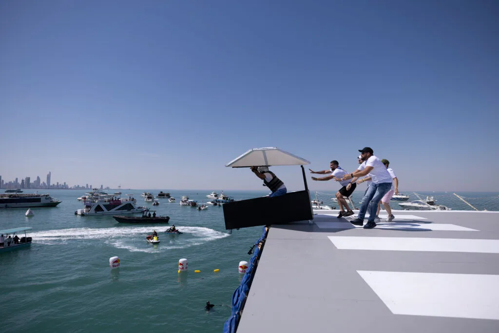 Man cliff diving into ocean.