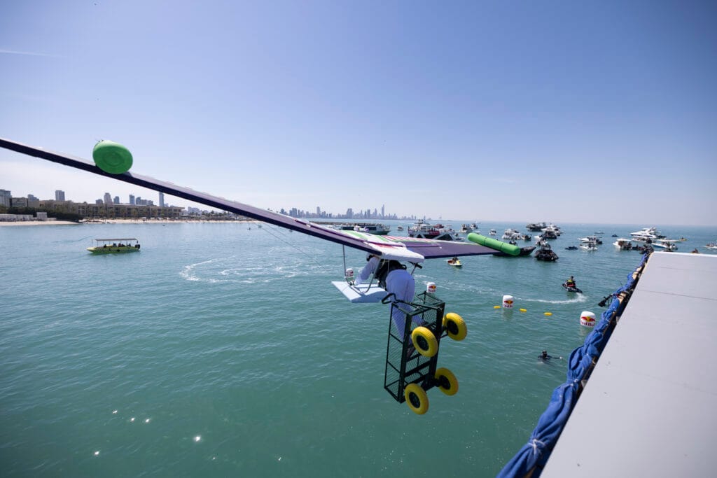 Hang glider over ocean.