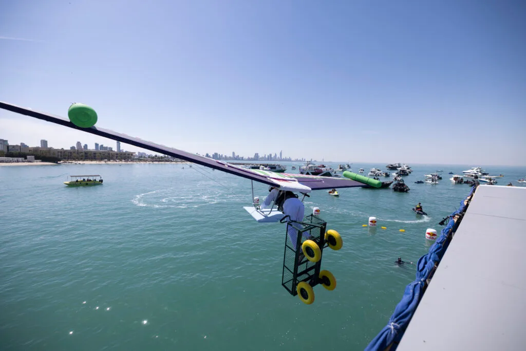 Hang glider over ocean.