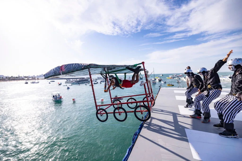 Man flying off makeshift bike.