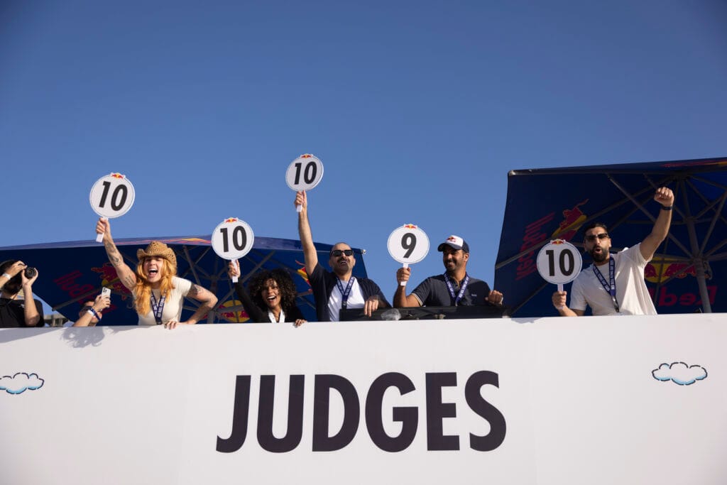 Judges hold up scorecards.