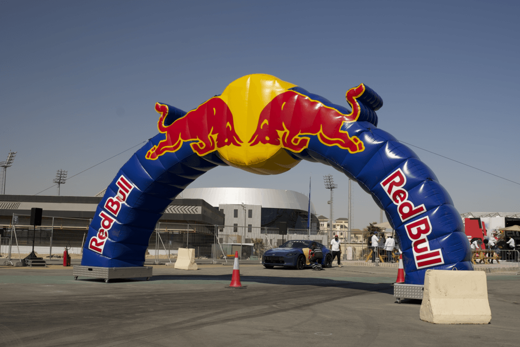 A large inflatable Red Bull arch at an event, showcasing image.
