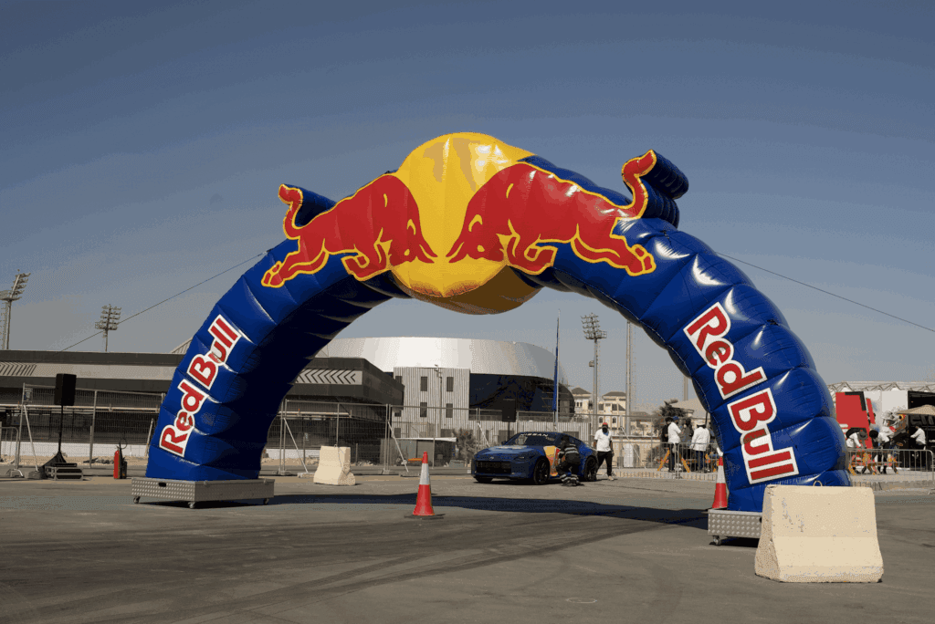 A large inflatable Red Bull arch at an event, showcasing image.