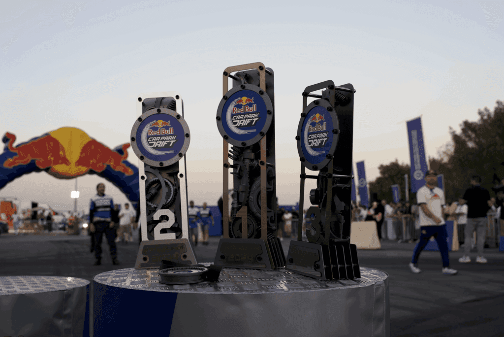 Three trophies for the Red Bull Car Park Drift event displayed on a podium, highlighting image.