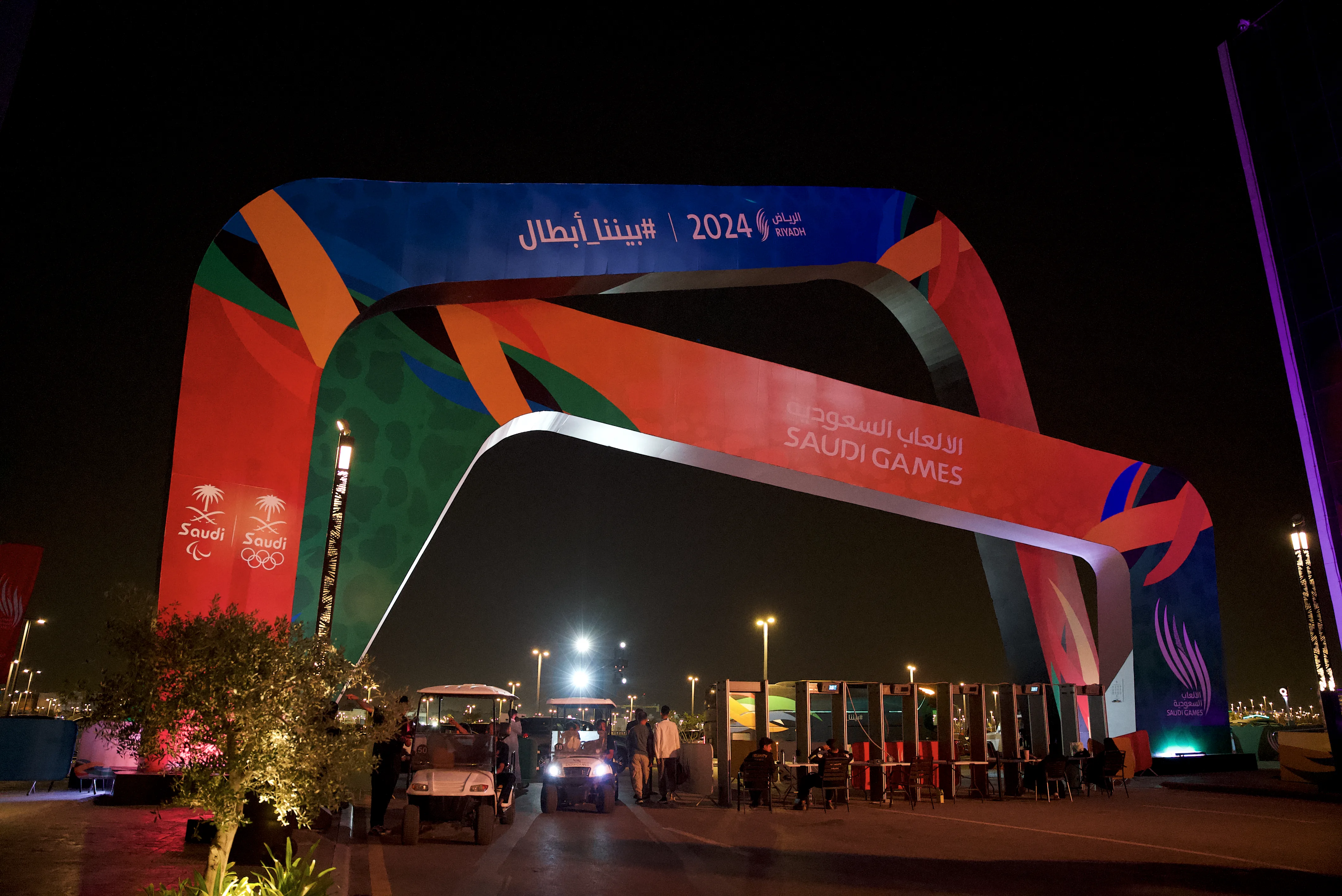 A vibrant archway for the Saudi Games 2024 illuminated at night, showcasing image.