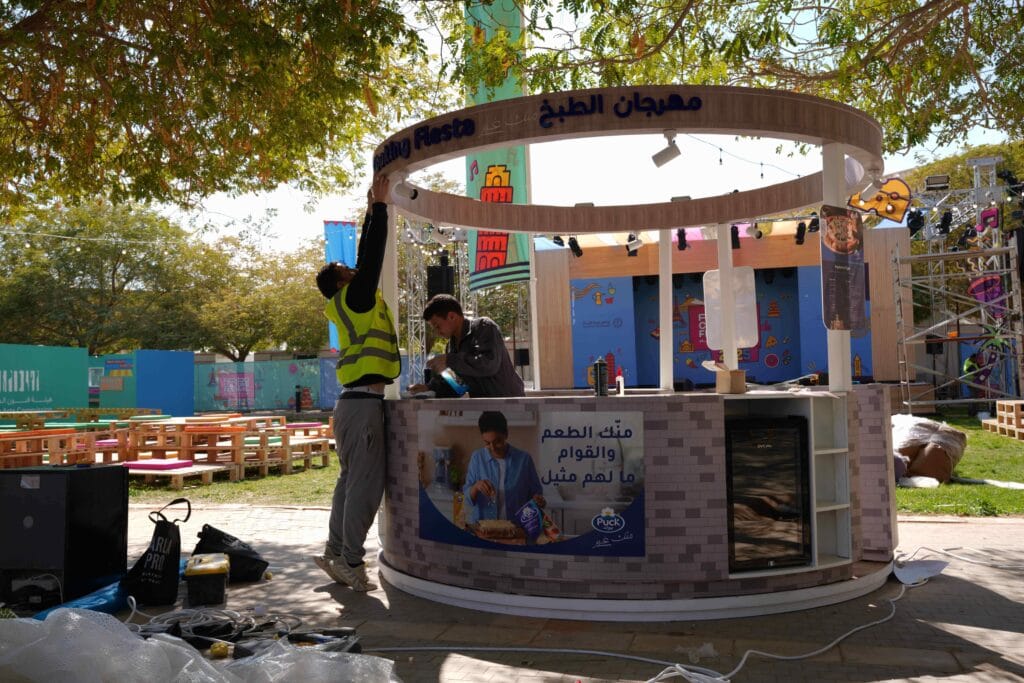 Workers setting up food booth.