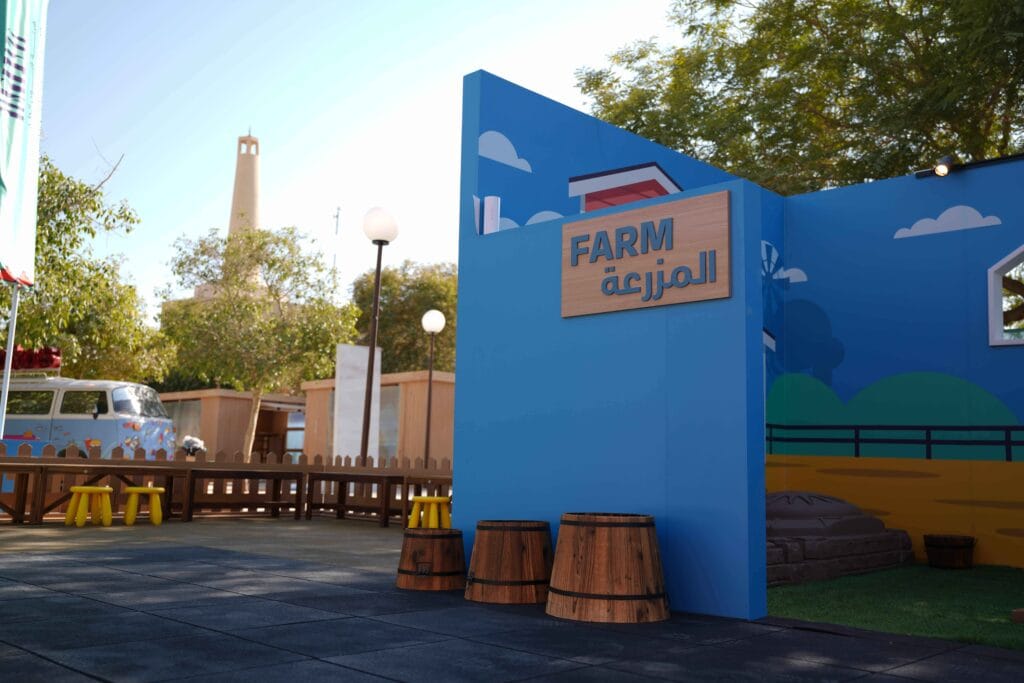 Farm sign, barrels, outdoor scene.