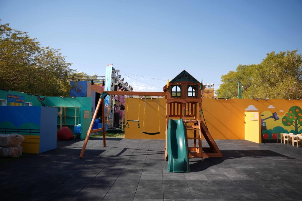 Wooden playground with slide and swings.