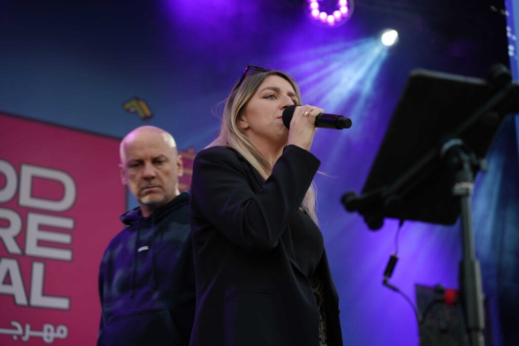Woman singing into microphone.