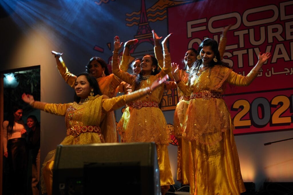 Women in yellow performing dance.