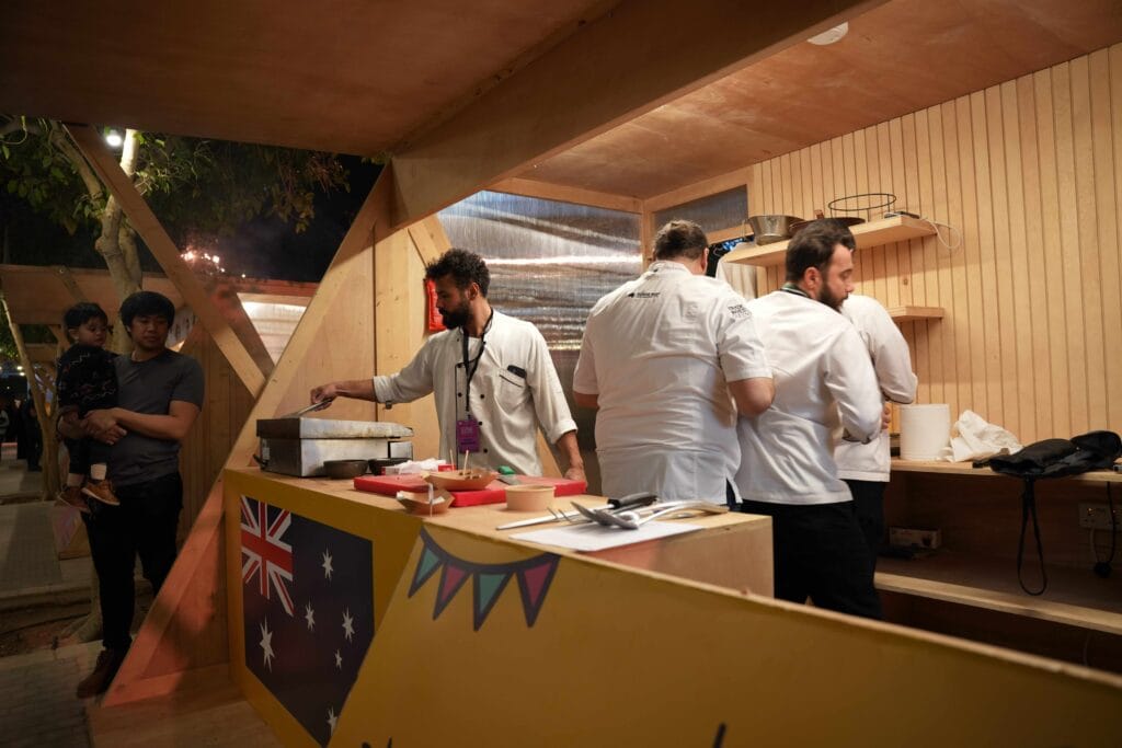 Australian food stall chefs cooking.