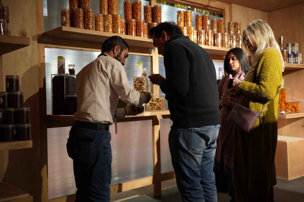 People shopping for snacks in store.