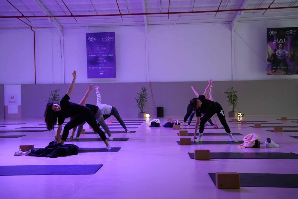 Women doing yoga indoors.