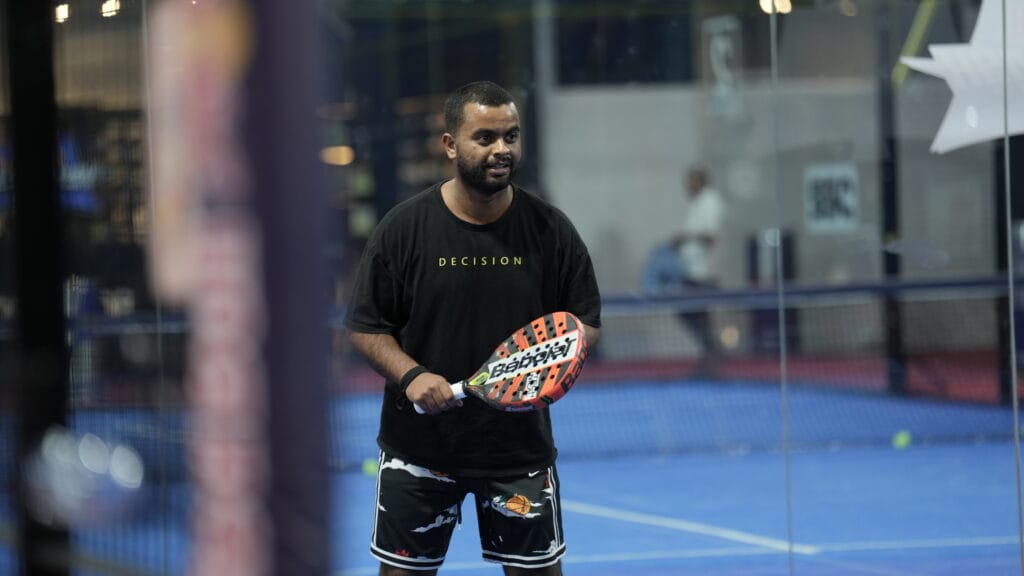 Man playing padel tennis.