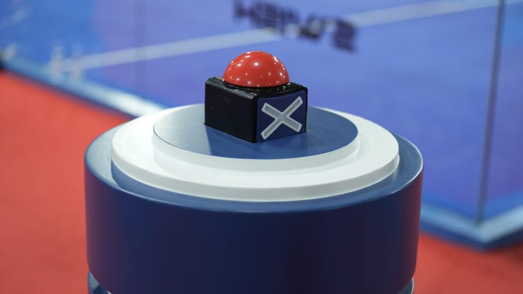 Red button, X marked base.