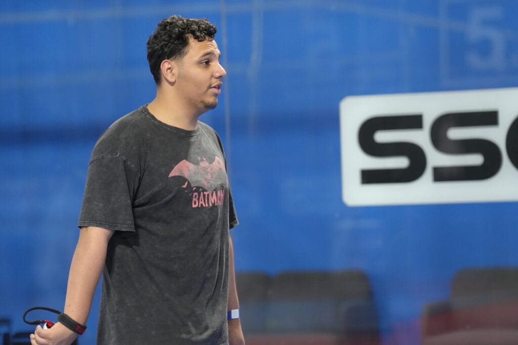 Man in Batman shirt waiting.