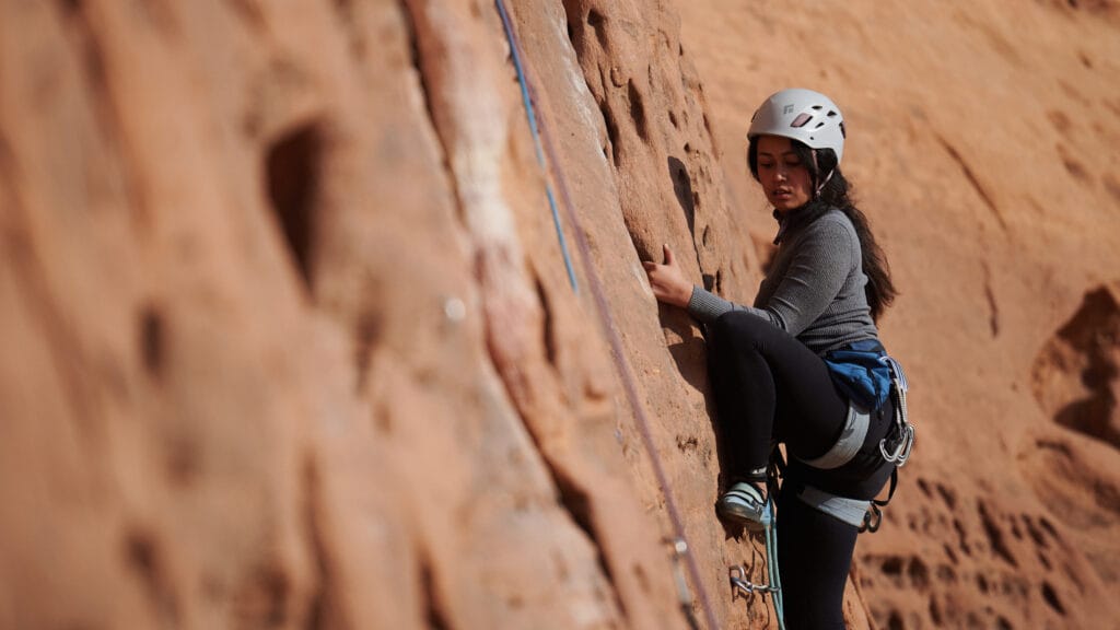 Woman rock climbing outdoors.
