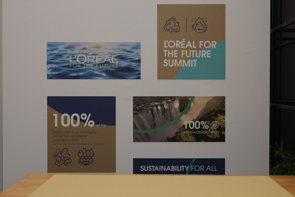L'Oreal for the Future Summit display featuring sustainability messages and visuals, highlighting image.
