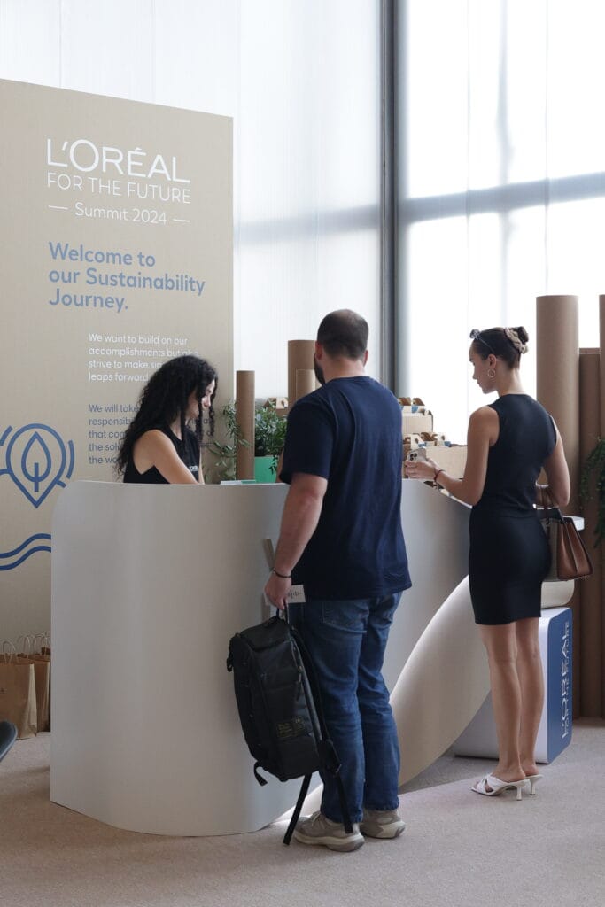 Attendees engaging at the L'Oréal for the Future Summit 2024 reception, highlighting sustainability image.
