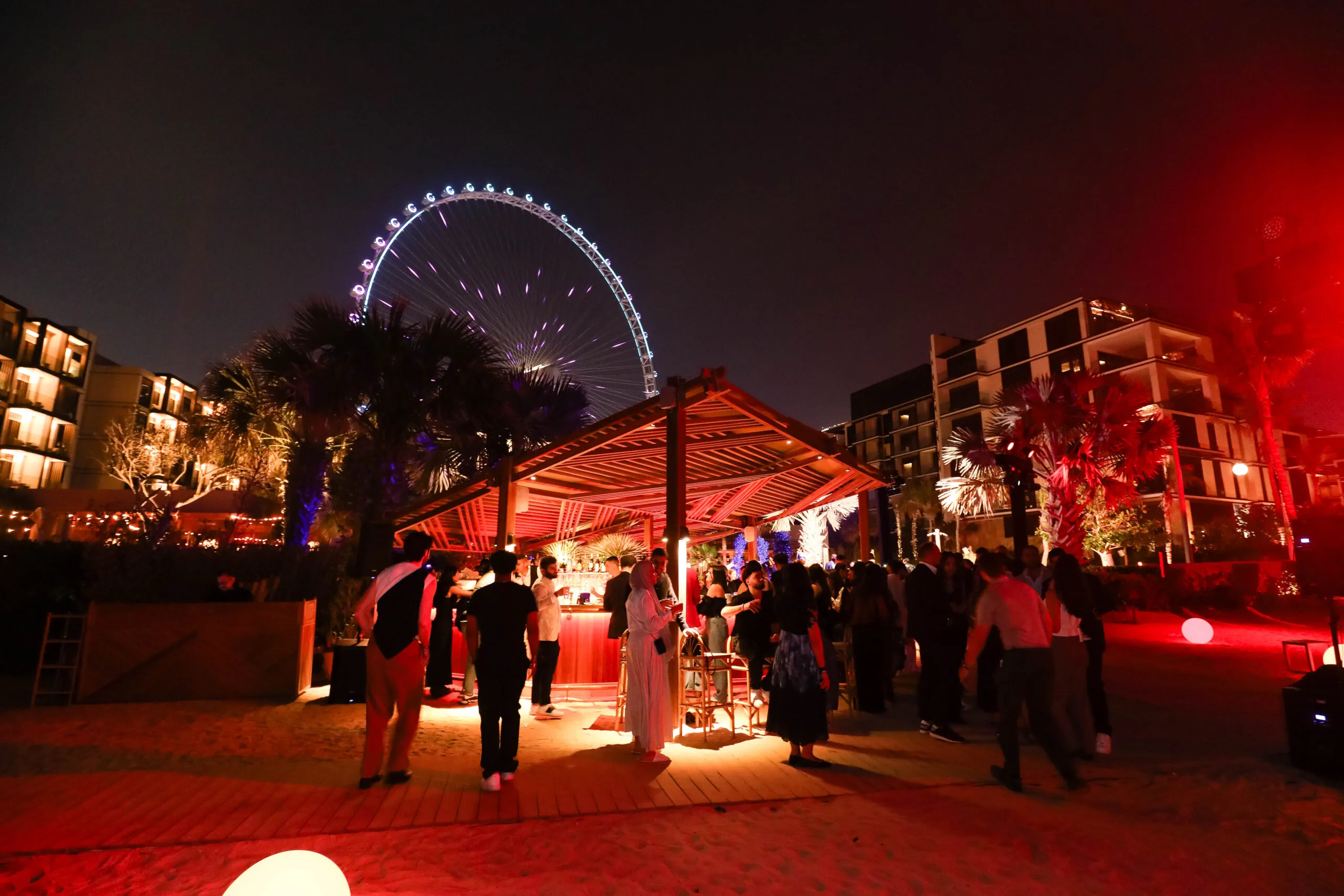 Night beach party, Ferris wheel.