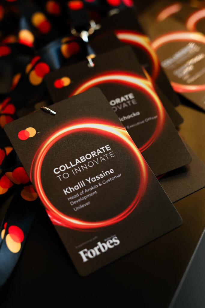 Name tags for the 'Collaborate to Innovate' event featuring a black background and colorful design, showcasing image.