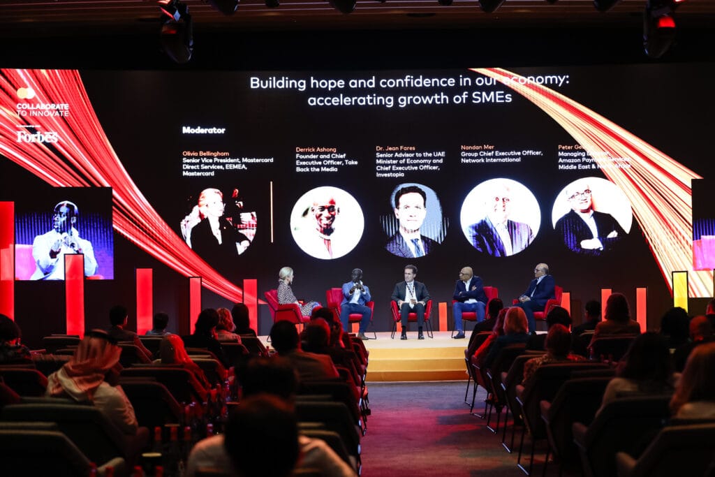 Entrance to the Forbes event featuring a black arch with red and yellow accents, showcasing the theme 'Collaborate to Innovate' in the image.