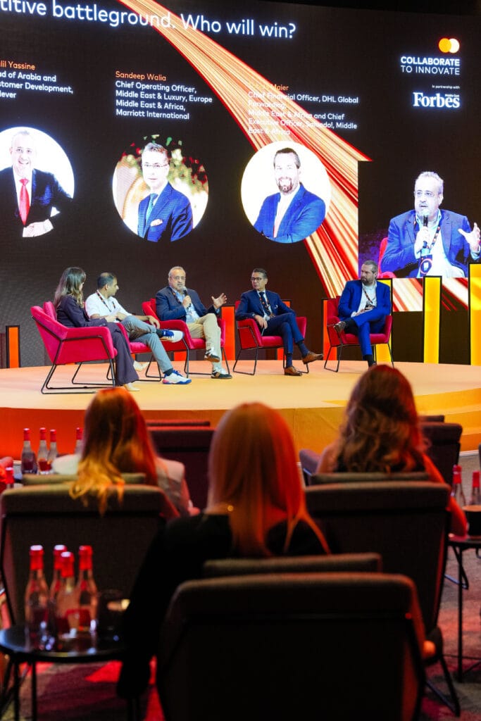 A panel discussion featuring business leaders at a conference, highlighting image.