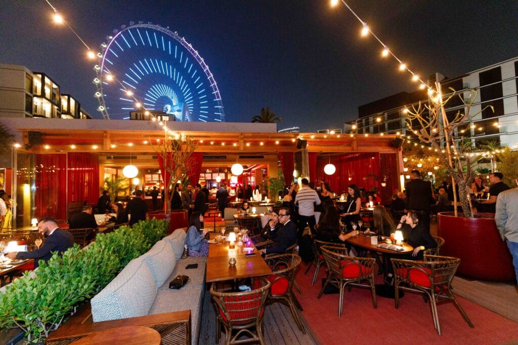 Nighttime rooftop bar scene.